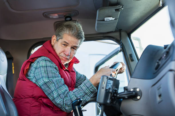 istock Senior Hispanic man driving semi-truck 1206536700