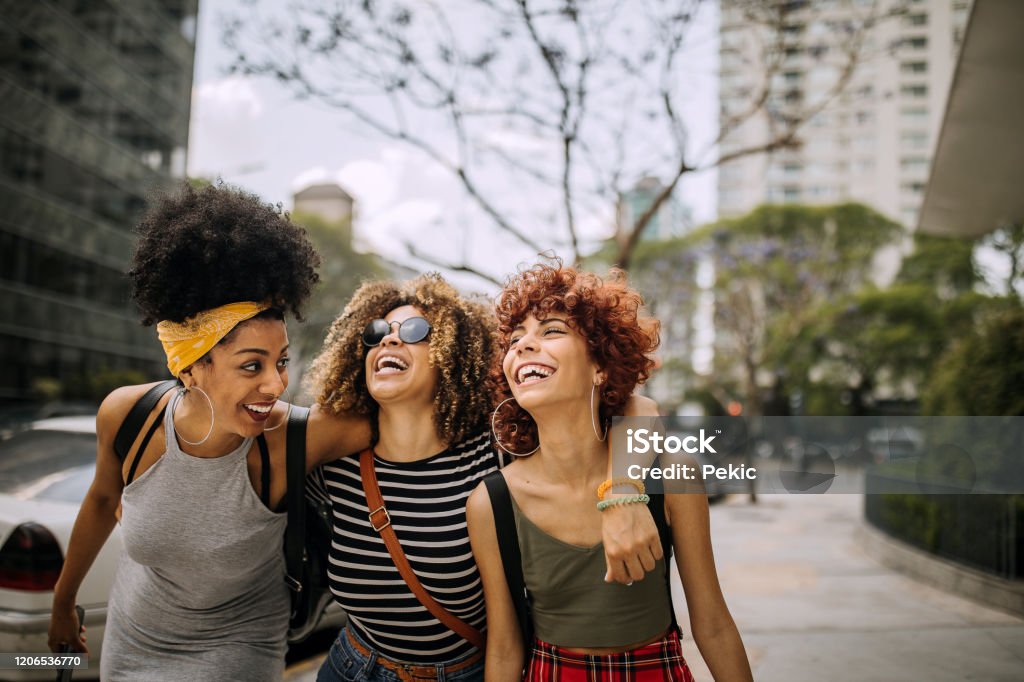 Three girlfriends having fun in the city Friendship Stock Photo