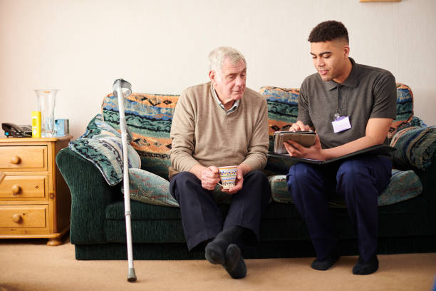 support worker with client - senior adult home caregiver care community outreach imagens e fotografias de stock