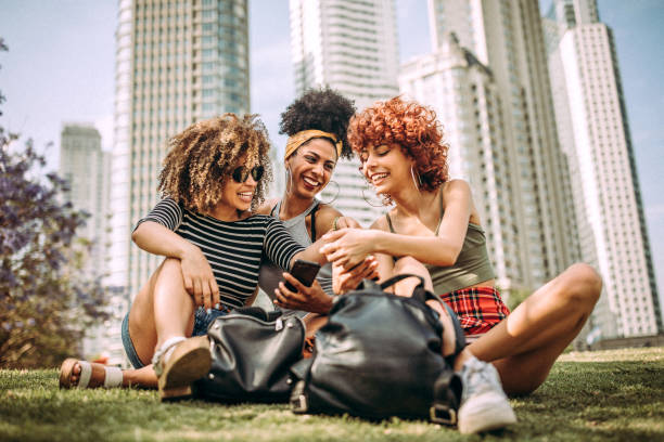 istock Three happy curly girlfriends in city 1206536877