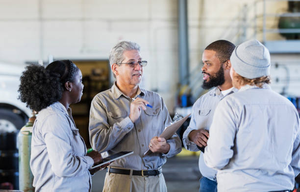 istock Workers in repair shop having a meeting 1206538223