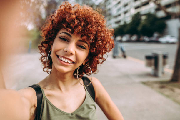 istock Cute Hispanic Redhead Woman Making A Selfie 1206538328