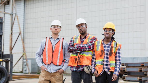 istock Three construction workers in hardhats and safety vests 1206538522