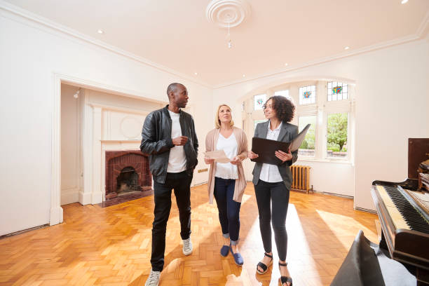 istock househunt couple with agent 1206540024