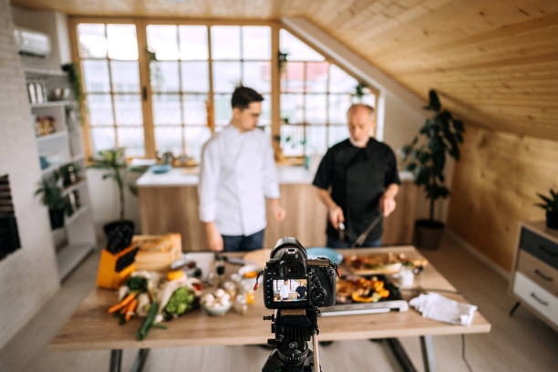 istock Camera Filming Young Man and his father preparing Meat At Kitchen 1206540654