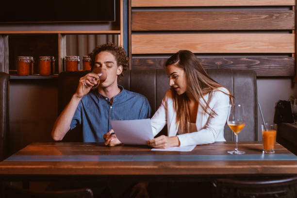istock Businesswoman guiding man with paperwork 1206543913