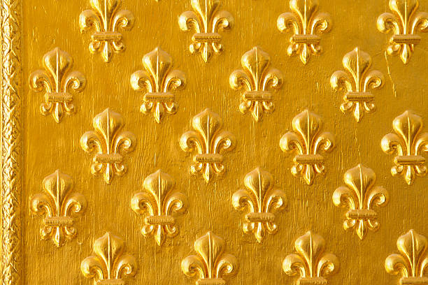 Close up of ornated golden door with a decorative flower symbol pattern.
