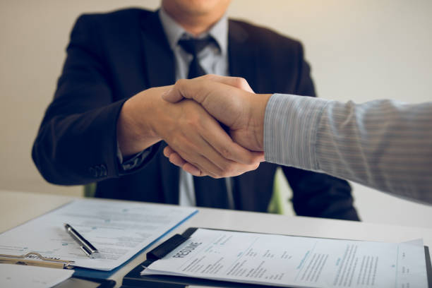 istock Manager and employee interview concept with handshake after talking about contract signing. 1206553708