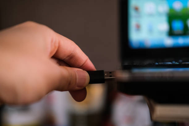 istock Plugging a USB cable into a port of a laptop 1206554349
