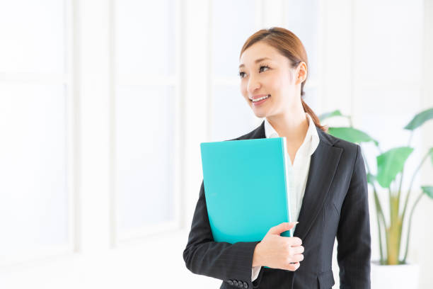 istock asian woman with files 1206557015