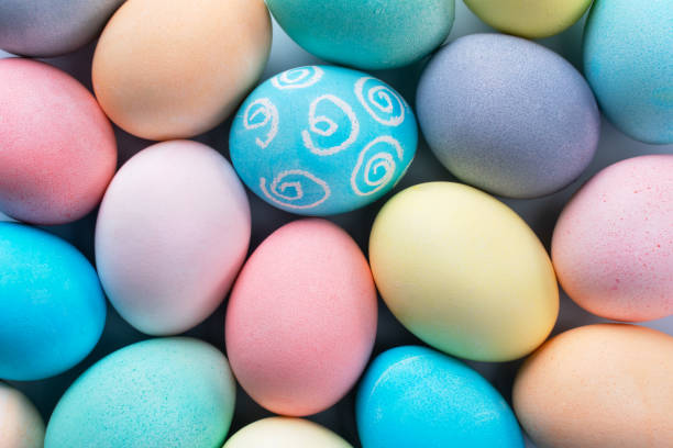 istock Colorful Easter eggs dyed by colored water isolated on a pale blue background, design concept of Easter holiday activity, close up, copy space. 1206561246