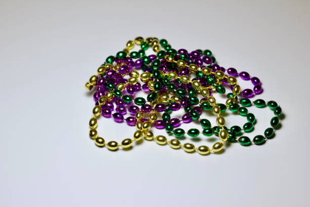 istock Traditional Mardi Gras bead necklaces on white background 1206565552