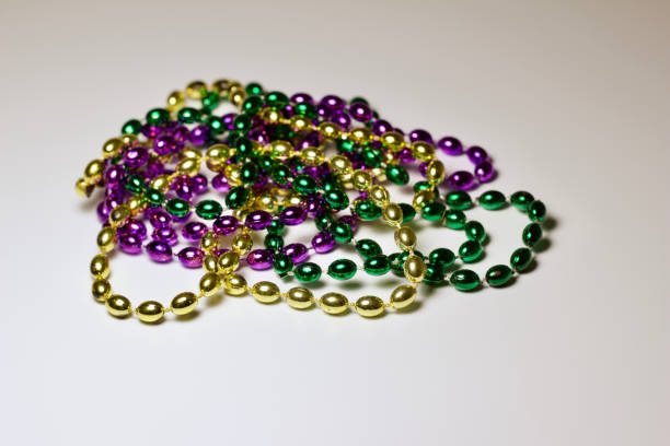 istock Traditional Mardi Gras bead necklaces on white background 1206566288