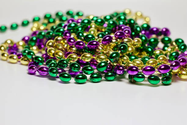 istock Traditional Mardi Gras bead necklaces on white background 1206566300