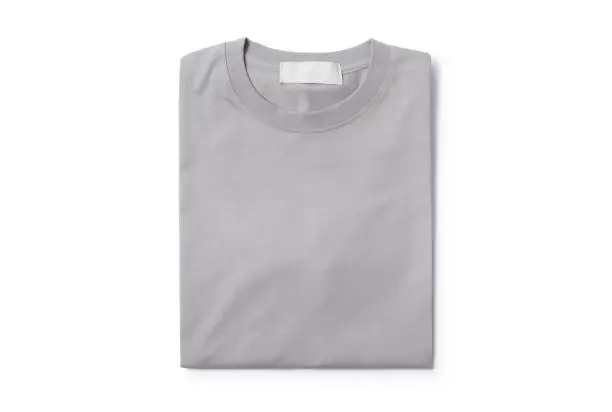 Photo of Grey folded t-shirt isolated on white background with clipping path