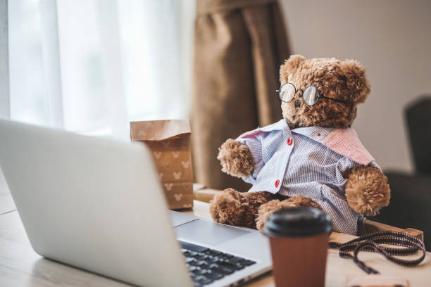 istock Teddy bear. A cute fluffy teddy bear plush doll wearing glasses in working concept. 1206571422