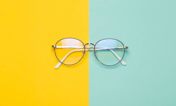 istock Eye glasses isolated on yellow and blue background 1206571553