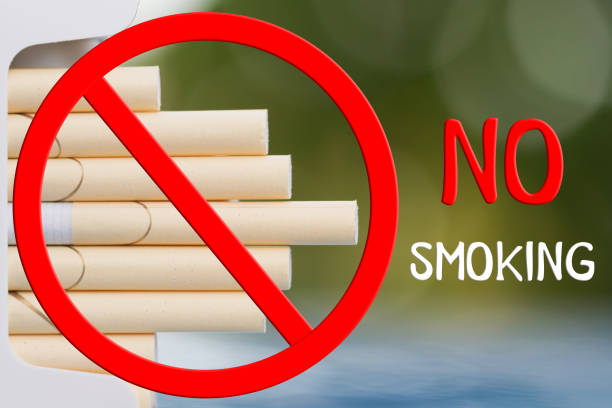 istock Concept. No smoking. Open pack of cigarettes. Green blur background, closeup, selective focus. 1206572271
