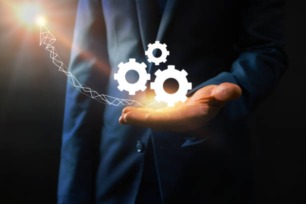 istock businessman holding cogs working and arrow up to success 1206572590
