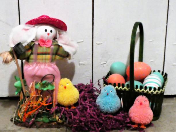 istock Country Style Easter Rabbit, Chicks and Eggs in a Basket With a Rustic White Wood Painted Background 1206574303