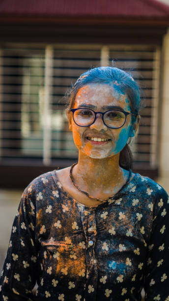 istock girl celebrating holi with colors 1206574374