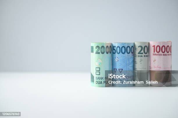 Indonesian Rupiah Rolled Banknotes On White Background Stock Photo - Download Image Now
