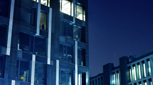 istock Night architecture - building with glass facade. Modern building in  business district. Concept of economics, financial. 1206578962