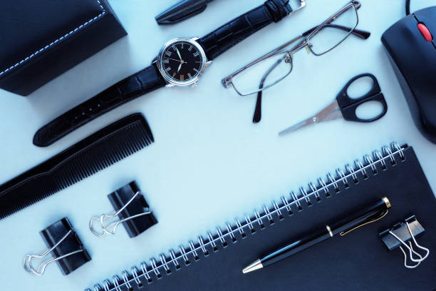 istock Gray desktop with a glider, tablet, glasses, clock, pens, scissors, clamps, computer mouse. Top view, flat layout. Space for text. 1206581156