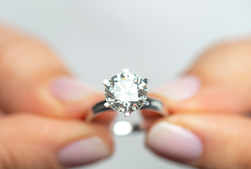 Woman showing a diamond ring.