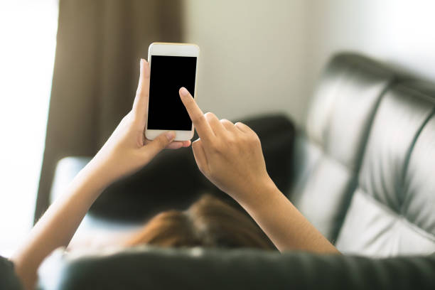 istock women using smartphone on black sofa at home 1206582950