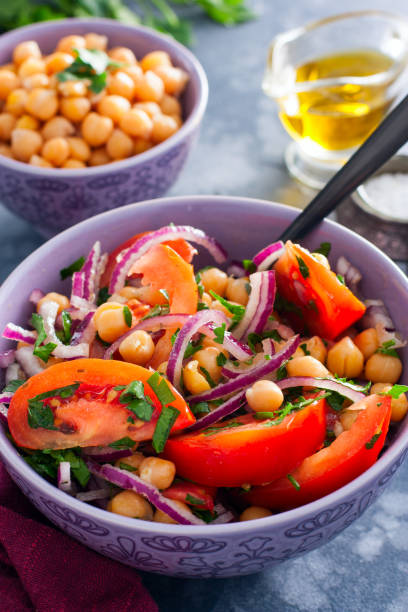 istock Salad with tomatoes, chickpeas and red onions, selective focus 1206583542