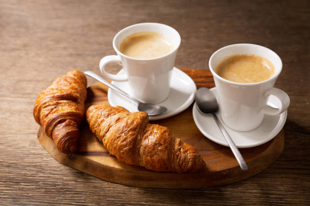 istock cups of coffee and croissants 1206585263