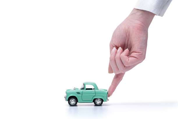 Woman’s hand assists the toy car to drive Woman’s hand assists the toy car to drive toy car stock pictures, royalty-free photos & images