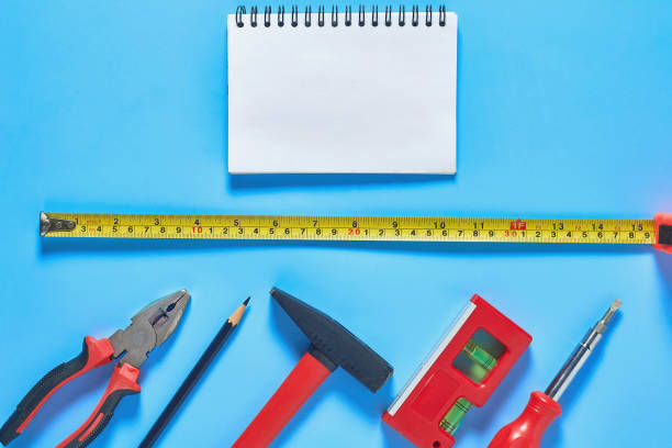 istock Different tools lies near blank paper notebook on blue desk in workshop. Space for text. Top view 1206589089