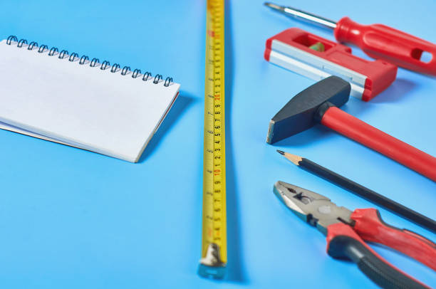 istock Different tools lies near blank paper notebook on blue desk in workshop. Close-up 1206589093