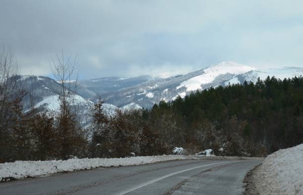 istock mountain road, winter in the snow 1206589209