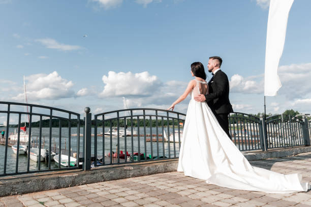 istock bride and groom standing on the bridge. 1206590932
