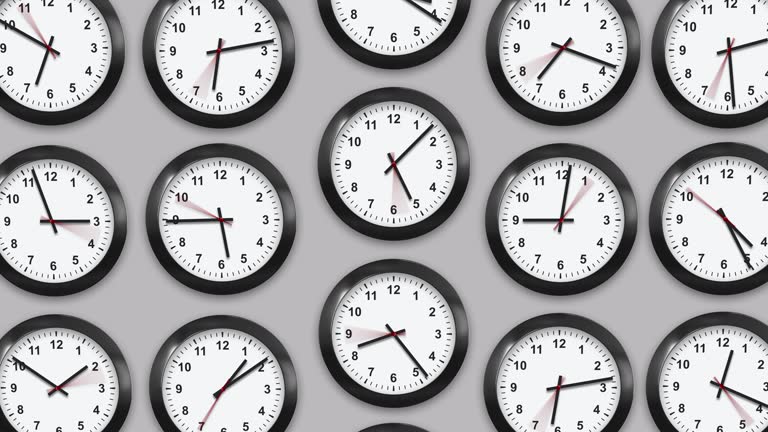 Multiple wall clocks in white background.