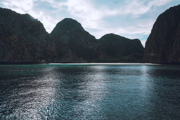 A secluded white sand beach surrounded by high pilar limestones at the Phi Phi Islands in the Krabi Province of Thailand
