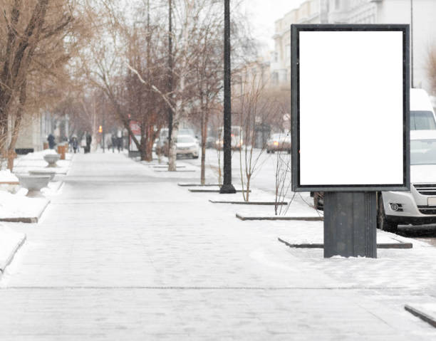 istock Empty clean white Billboard on a city street. Snow is falling 1206593906