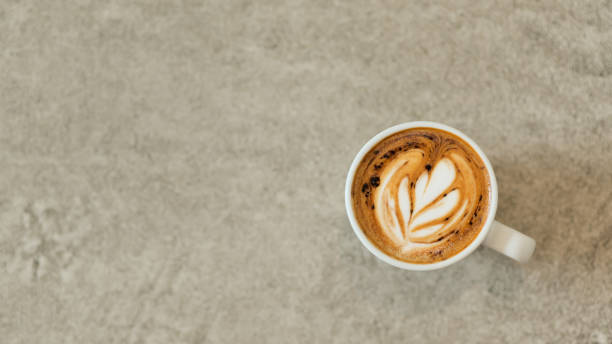 istock Heart shaped coffee latte stacked in white glass on a concrete floor. 1206594948
