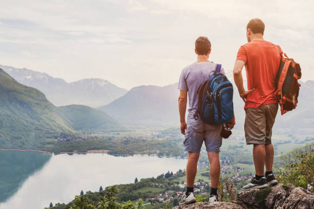 istock hiking travel adventure, two backpackers in Alps 1206594991