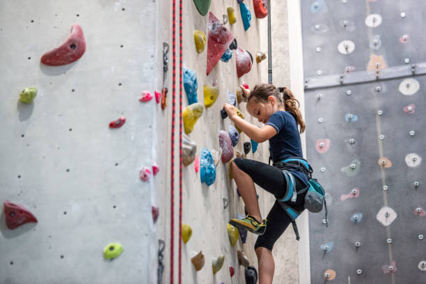 istock Girl climbing on climbing wall 1206595562