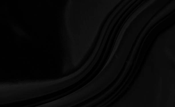 istock Black gray satin dark fabric texture luxurious shiny that is abstract silk cloth background with patterns soft waves blur beautiful. 1206595702