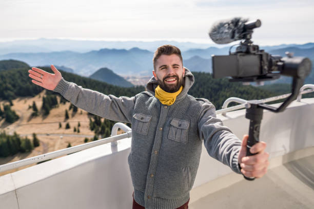 istock Influencer recording video message from the mountains top 1206596845