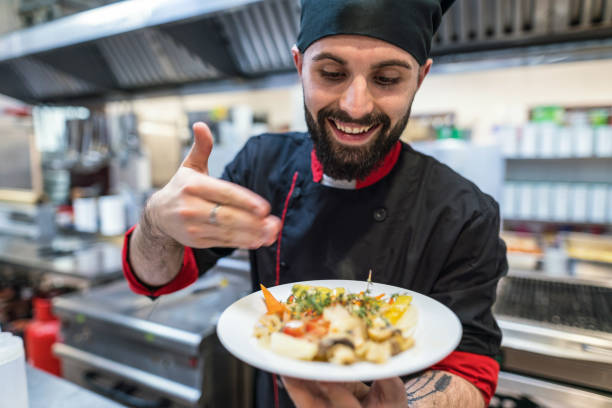 istock Excited young chef presenting gourmet cheese appetizers 1206596853