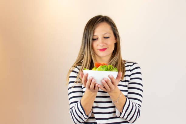 istock Woman with a salad in her hands 1206597265
