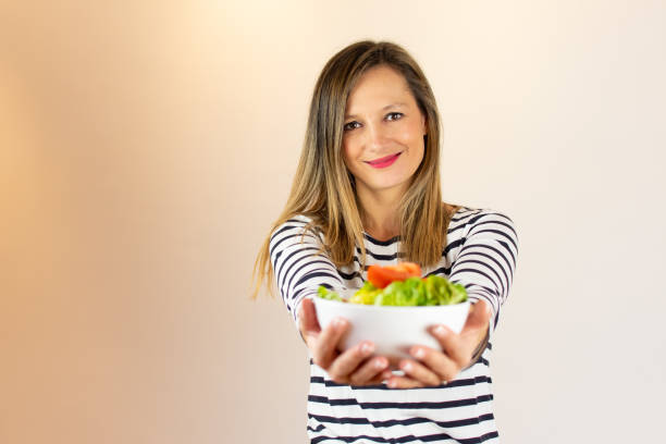 istock Woman with a salad in her hands 1206597280
