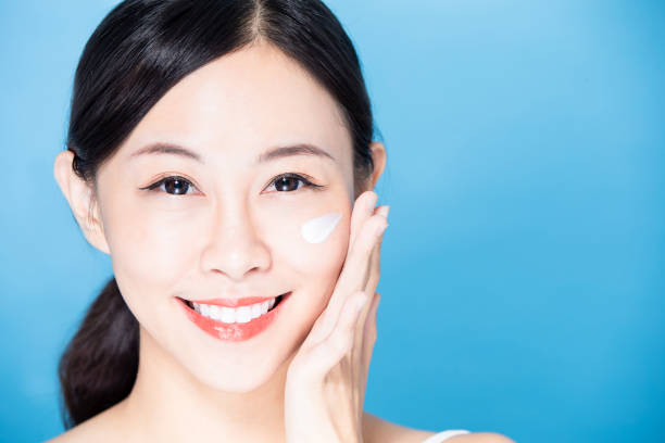 istock woman apply sunscreen on face 1206597878