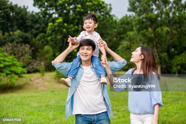 Young Parents Show The View To Kid Stock Photo - Download Image Now - Family, Asia, Natural Parkland